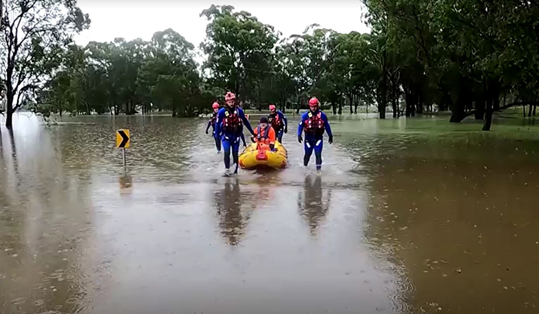 Rescuers help elderly resident escape floodwaters in Australia