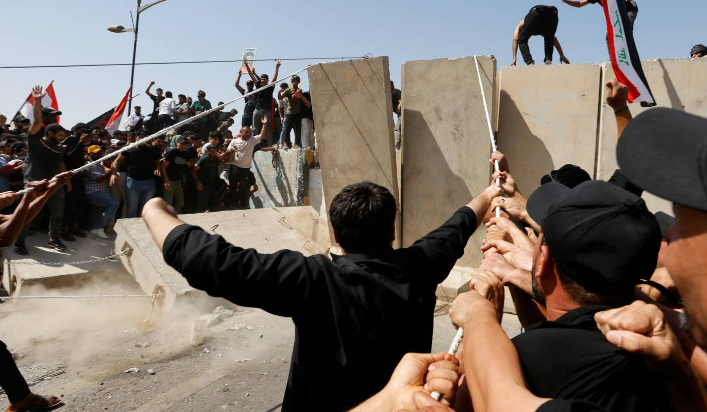 Supporters of Iraqi cleric Moqtada al-Sadr pull down blast wall in Baghdad