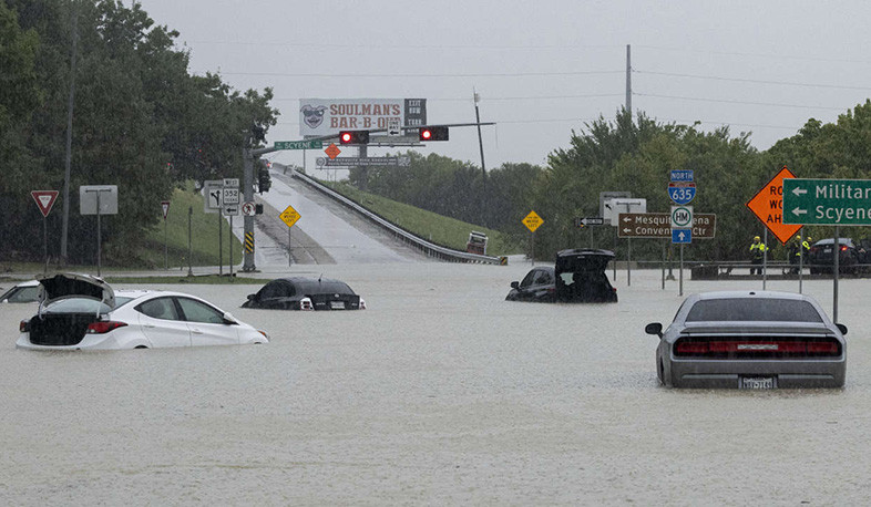 Residents wade through waist-high water after Texas floods