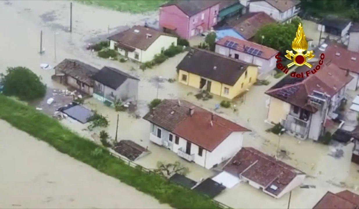 Water flows down the street, as floods hit Italy's northern Emilia-Romagna region