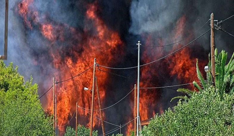 Greek firefighters battle to try control wildfire on islands