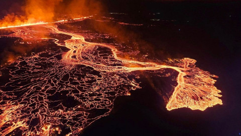 Aerial footage shows Iceland volcano spewing lava at night